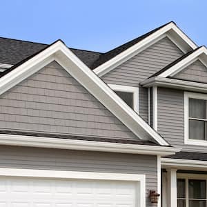 grey home with shingles and gutters   